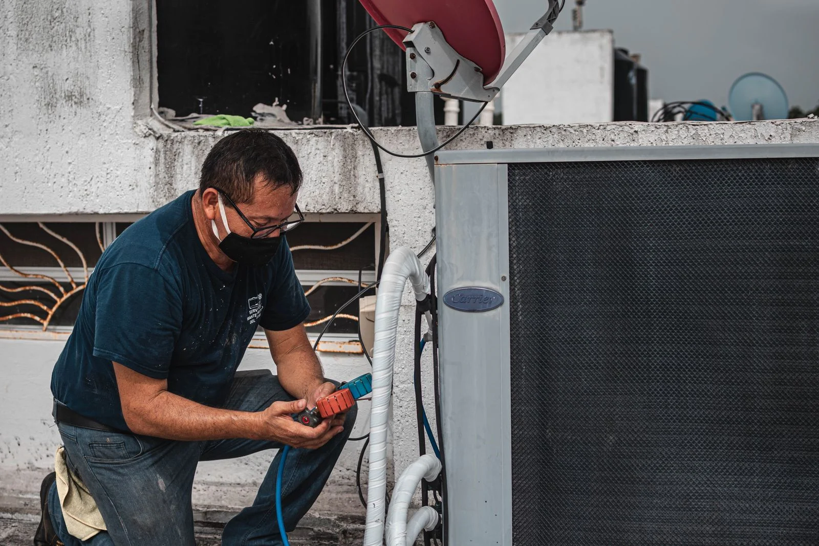 Technician servicing an outdoor air-conditioning unit